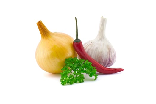 Garlic bulb, green parsley twig, golden-brown onion and fresh small red chili pepper isolated on white background