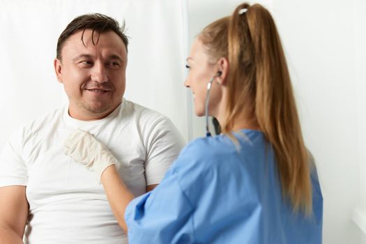 female doctor examining patient male health hospital. High quality photo