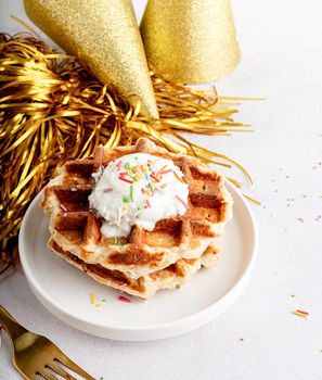 Birthday party waffles decorated with youghurt and colorful sprinkles