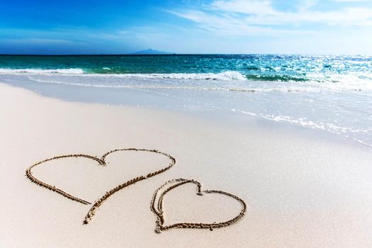 Drawing hearts on beach, love Valentines day concept