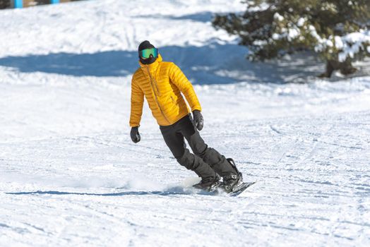 Grandvalira, Andorra: 2021 January 03: Young man on snowboard in the Pyrenees at the Grandvalira ski resort in Andorra in Covid19 time