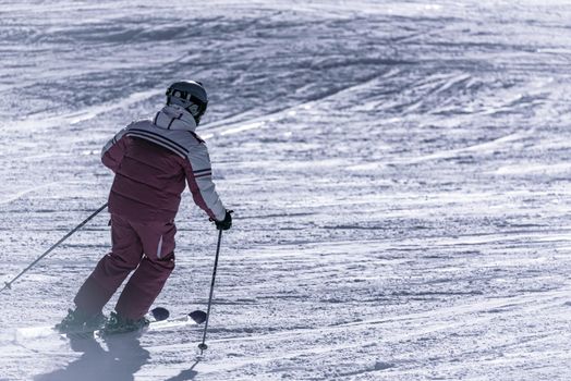 Grandvalira, Andorra: 2021 January 03: Old man skiing in the Pyrenees at the Grandvalira ski resort in Andorra in Covid19 time
