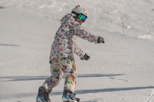 Grandvalira, Andorra: 2021 January 03: Young woman on snowborad in the Pyrenees at the Grandvalira ski resort in Andorra in Covid19 time
