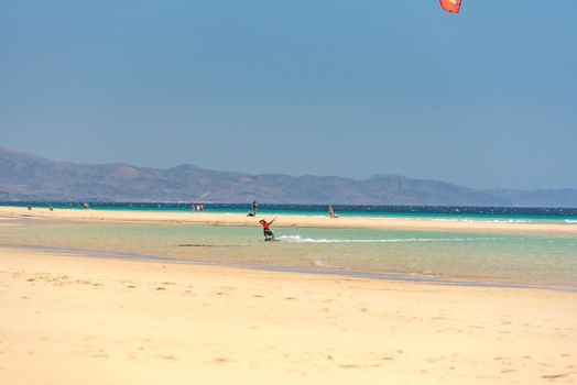 Sotavento, Fuerteventura, Spain: 2020 October 8: Man practicing kitesurfing in Playa de Sotavento, Fuerteventura in Spain in summer.