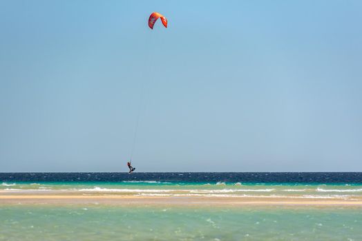 Sotavento, Fuerteventura, Spain: 2020 October 8: Man practicing kitesurfing in Playa de Sotavento, Fuerteventura in Spain in summer.