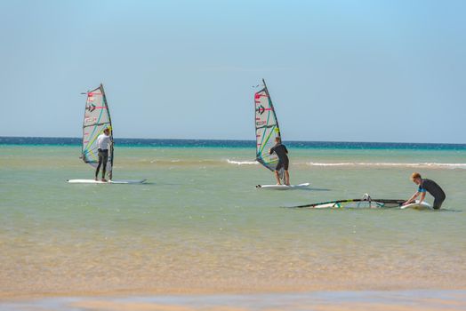 Sotavento, Fuerteventura, Spain: 2020 October 8: Man learning Windsurfing at Playa de Sotavento, Fuerteventura in Spain in summer.