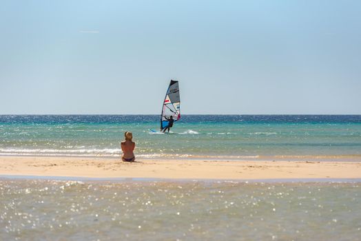 Sotavento, Fuerteventura, Spain: 2020 October 8: Man learning Windsurfing at Playa de Sotavento, Fuerteventura in Spain in summer.