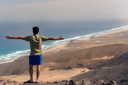 Cofete, Spain: 2020 october 7: Men looks at the Landscape of the Cofete Beaches in Fuerteventura, Spain. looks at the Landscape of the Cofete Beaches in Fuerteventura, Spain.