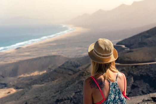 Cofete, Spain: 2020 october 7: Blonde Girl looks at the Landscape of the Cofete Beaches in Fuerteventura, Spain.