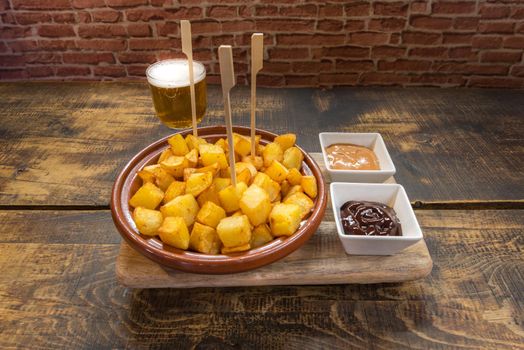 Patatas Bravas typical Spanish tapa on a rustic table.