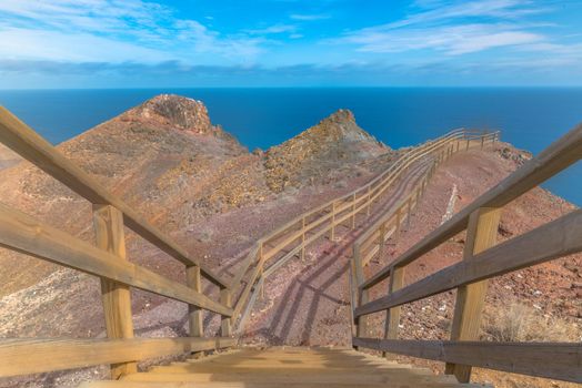 Blonde woman in the View Point in La Entallada lighthouse on the island of Fuerteventura, Spain.