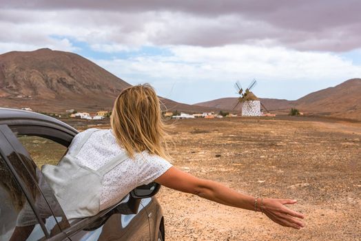 Young Blonde inside de car on the island of Fuerteventura in Spain.