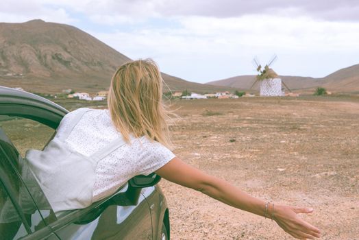 Young Blonde inside de car on the island of Fuerteventura in Spain.