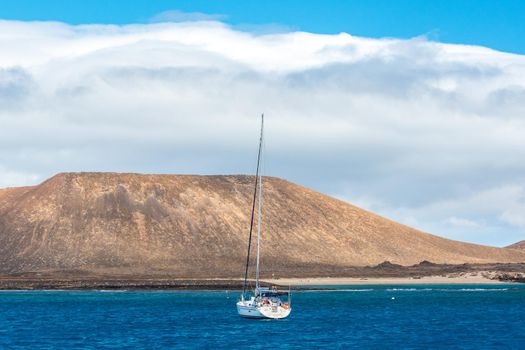 Corralejo, Fuerteventura, Spain: 2020 September 30: Boat in the sea near Corralejo in Fuerteventura in the Canary Islands in Spain.