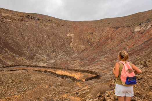 Corralejo, Fuerteventura, Spain: 2020 September 02: Young blonde girl on the Fuerteventura Nature Trail GR 131 from Corralejo to Morro Jable in summer 2020.