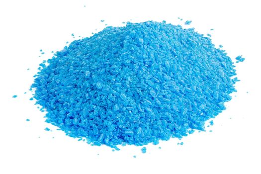 Pile of blue copper sulfate granules - close-up isolated on white background. Edge-to edge sharp.