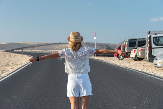 Corralejo, Fuerteventura, Spain: 2020 September 30: Blonde Tourist Girl with hat in the Parque Natual Dunas de Corralejo on Fuerteventura in Canary Islands in Spain.
