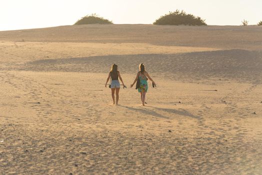 Corralejo, Fuerteventura, Spain: 2020 October 30: Two womans in the Dunas de Corralejo Natural Park in Fuerteventura, Spain in the fall of 2020.