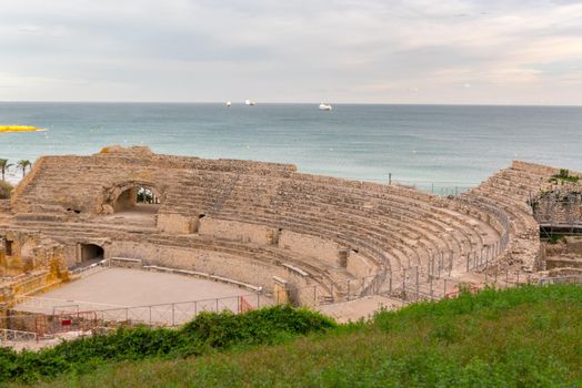 Sunny day in Tarragona Amphitheatre in Spain - A UNESCO World Heritage Site in summer.