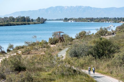 Ebro Delta, Spain: 2020 September: PEople wlaking in the Ebro River in summer in the port.