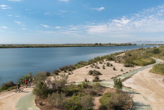 Ebro Delta, Spain: 2020 September: People in bike in the Ebro River in summer in the port.