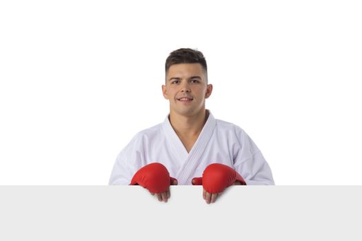 Man fighter training taekwondo with blank banner isolated on white background