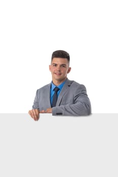 Young man in suit showing banner whiteboard sign isolated on white background