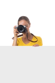 Portrait of young beautiful photographer girl with camera and blank banner isolated on white background