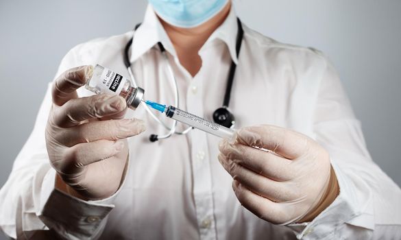 Doctor or nurse is injecting Coronavirus Covid-19 Vaccine preparing for vaccination concept