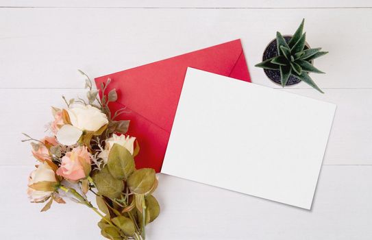 Valentine day, greeting card mockup and letter and flower on wooden table, postcard blank and gift with romance on desk, present in anniversary and celebration, top view, holiday concept.