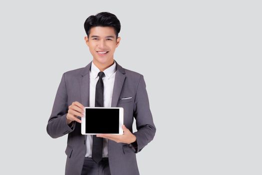 Portrait young asian business man showing and presenting tablet computer with blank with success isolated on white background, businessman standing and holding touchpad digital, communication concept.