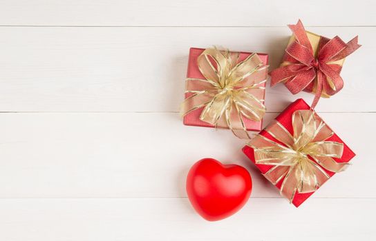 Gift box and heart shape on wooden table background, love and romance, presents in celebration and anniversary with surprise on desk, happy birthday, donate and charity, valentine day concept.