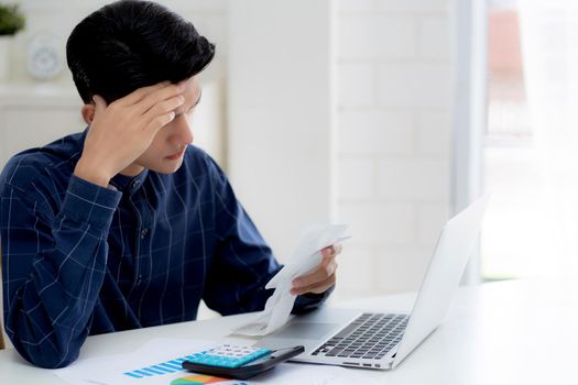 Young asian man calculating expenses household about finance and frustrated on desk at home, male checking bill having stress and worried, debt and tax, expression and emotion, business concept.