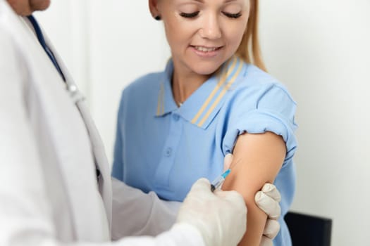 male doctor giving an injection to the patient's arm health vaccine. High quality photo