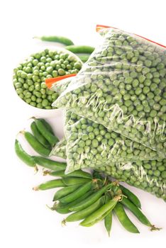 Composition with organic frozen vegetables on white background. Green peas in the package