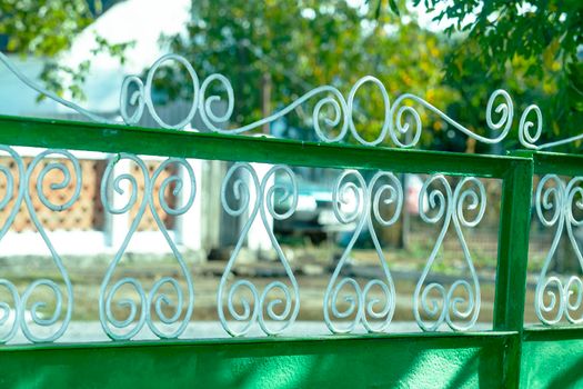 Painted white. The gate is green. Side view