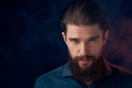 Cute bearded man in shirt elegant style close-up dark background. High quality photo