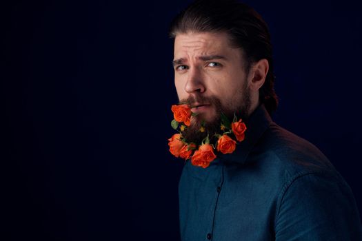Elegant man in a shirt flowers in a beard charm romance dark background. High quality photo