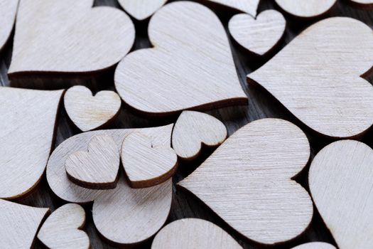Many wooden colorless hearts background, two special ones true love concept