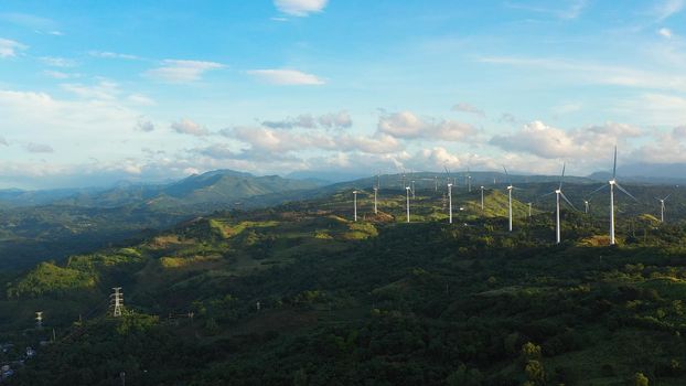Panorama with Wind turbines generating electricity view from above. Wind mills in the Philippines, Luzon.