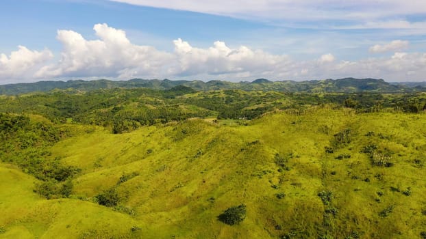 The nature of the Philippine Islands, Samar. Mountains and hills in clear weather. Tropical landscape with green hills and rice fields, aerial view. Summer and travel vacation concept.