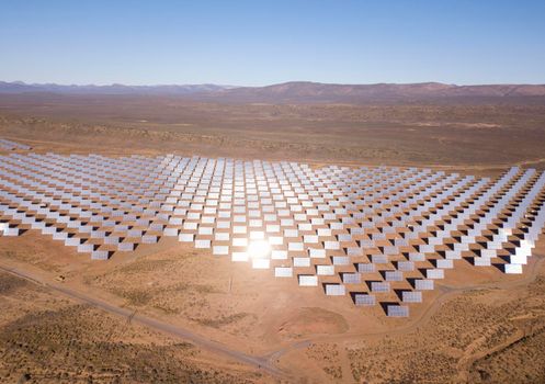 Aerial over solar panels in a dry landscape