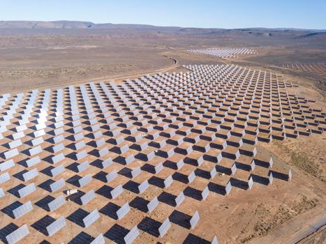 Aerial over solar panels in a dry landscape