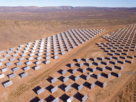 Aerial over solar panels in a dry landscape