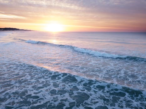 Aerial of sunrise over the ocean