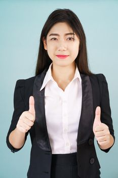 Asian business women in suit and thump up hand sign