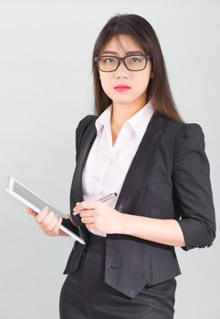 Young Asain women long hair in suit standing using her digital tablet computer