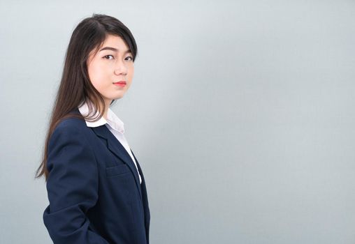 Portrait of asian business woman standing isolated on gray background