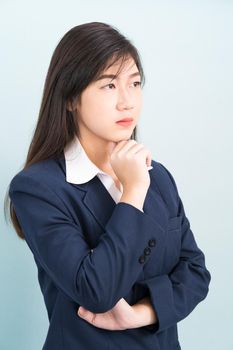 Teenage young girl wearing suit with hand on chin isolated on blue background