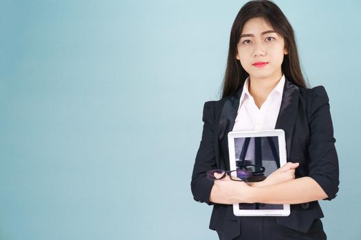 Young women standing in suit holding her digital tablet computor